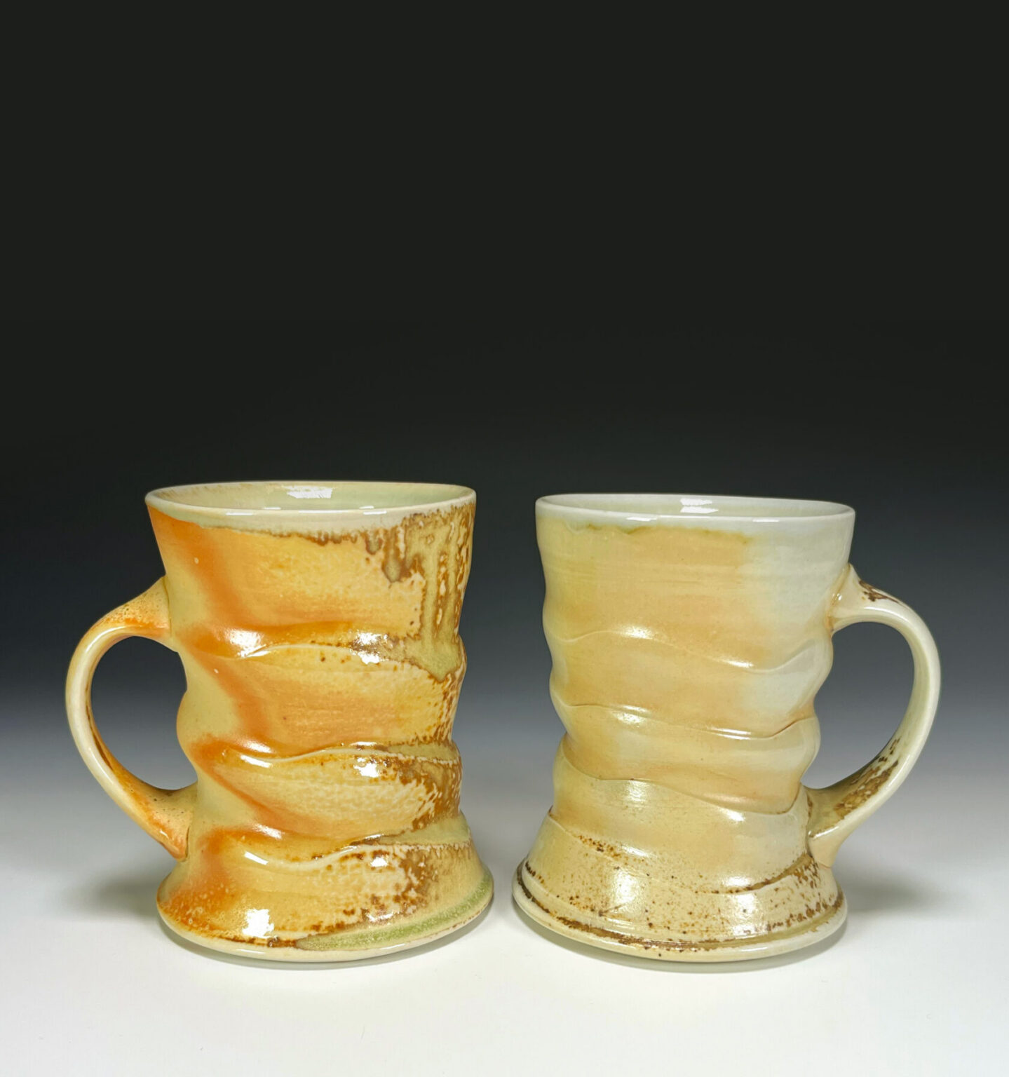Two wood-fired mugs