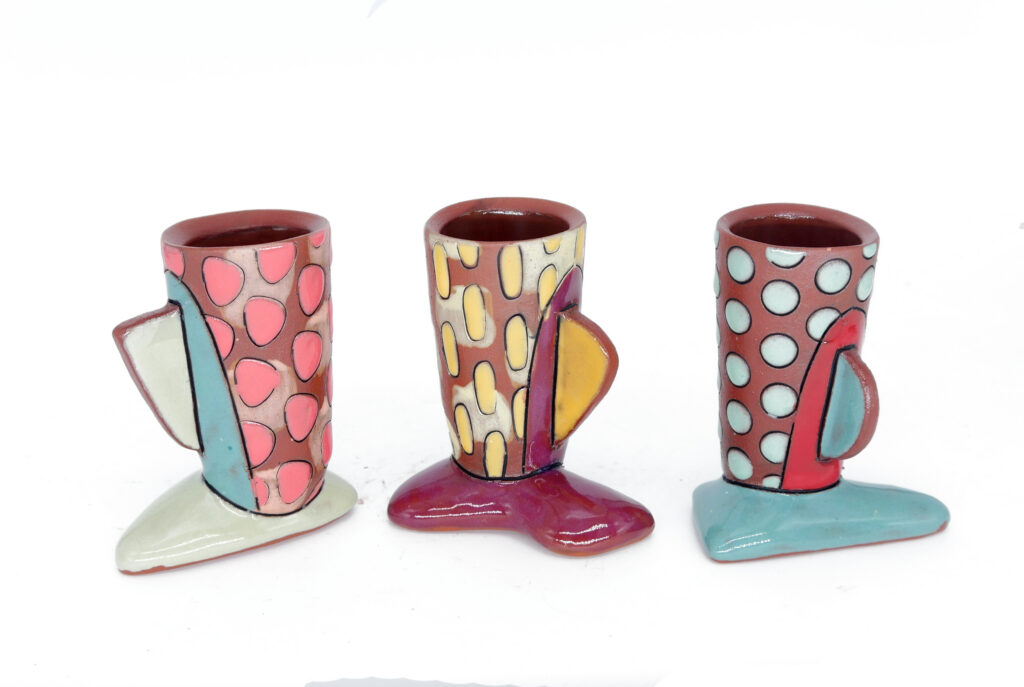 Three colorful patterned terracotta cups