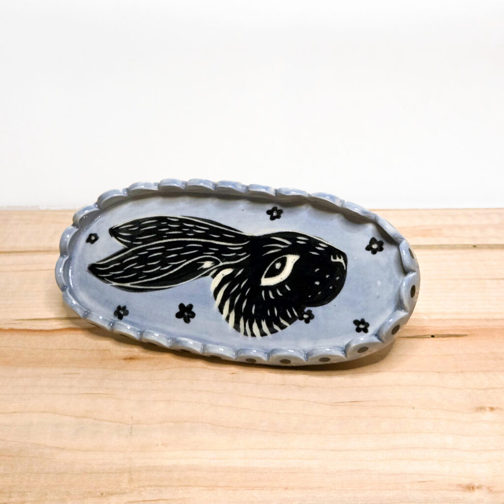 Oval dish with a carved rabbit design